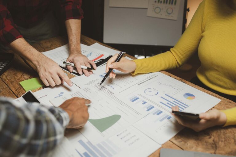group-of-businessmen-working-together-to-calculate-BGGDW4K.jpg